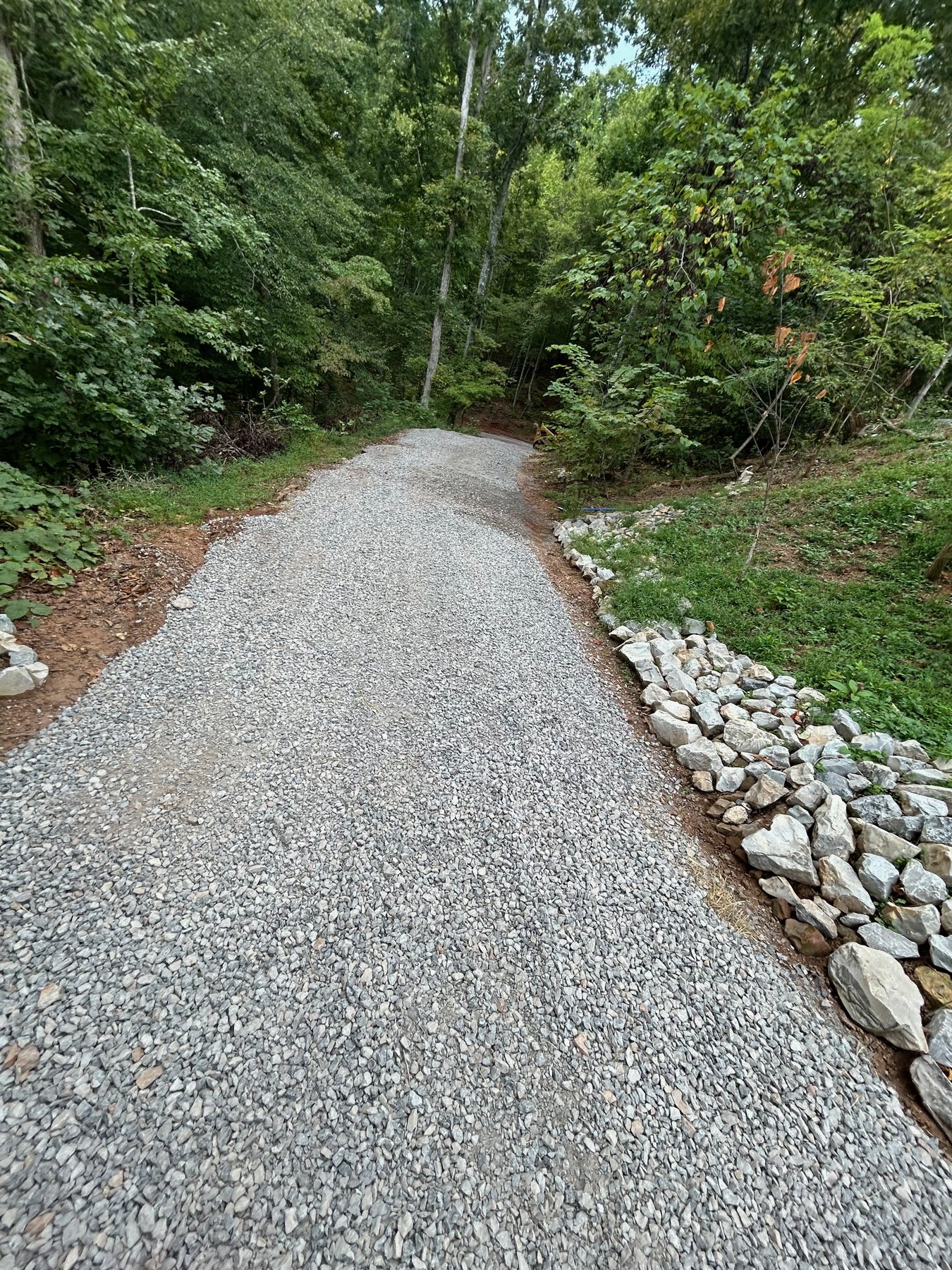Finished gravel driveway and stone edge installed by BECS