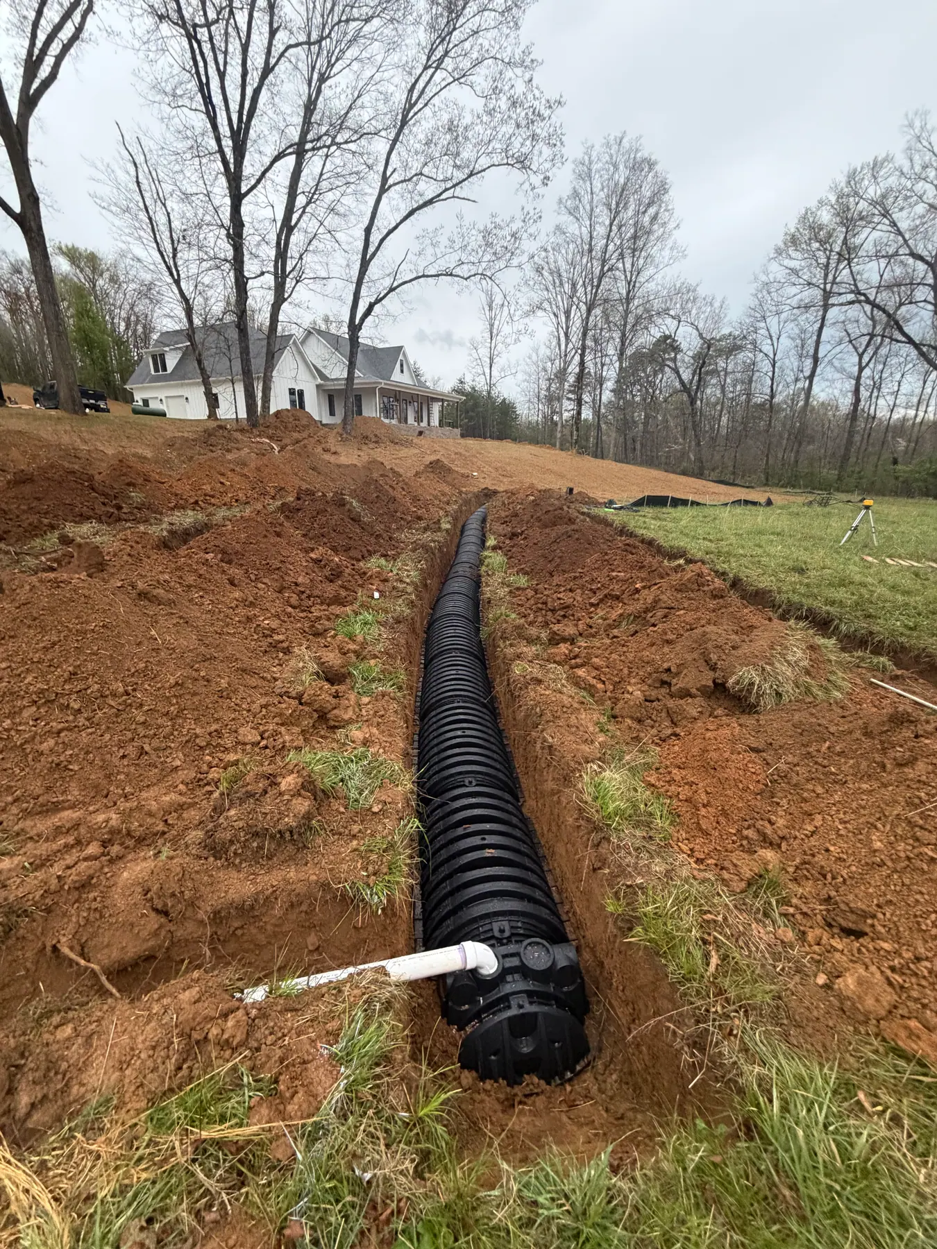 Septic chambers and connecting pipe laid in an excavated trench
