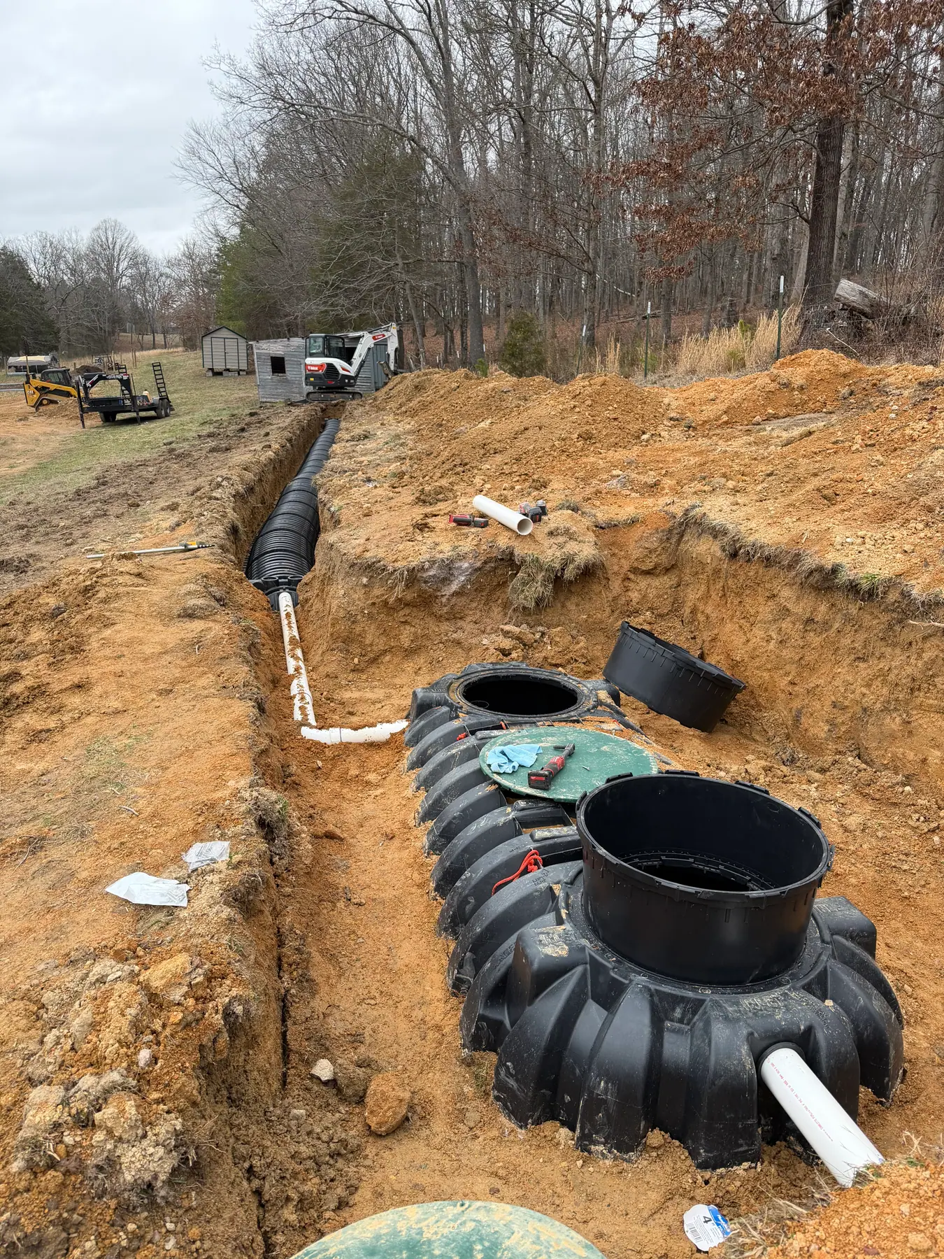 Septic tank, connecting pipe and chamber trench during installation